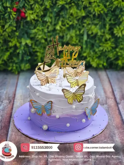 A beautiful butterfly cake in shades of purple and white. The golden butterflies add a touch of sparkle to this elegant design.
