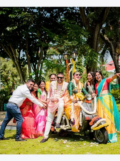 Another angle of the fun group photo on the scooter, capturing the playful spirit of the wedding party.
