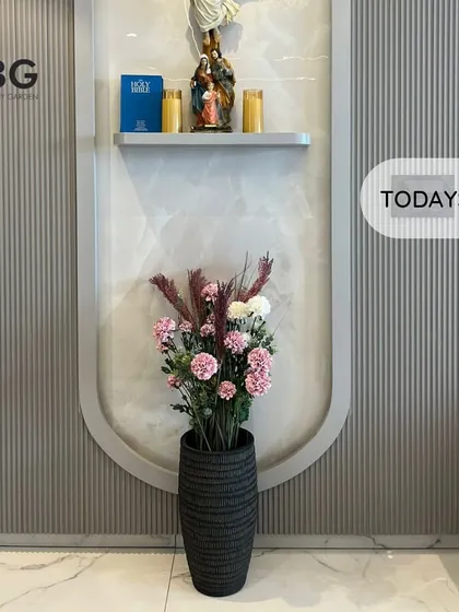 Today's delivery: a designer cement planter filled with a beautiful arrangement of artificial flowers. This is a great way to add color and softness to a formal space like a reception area or lobby.
