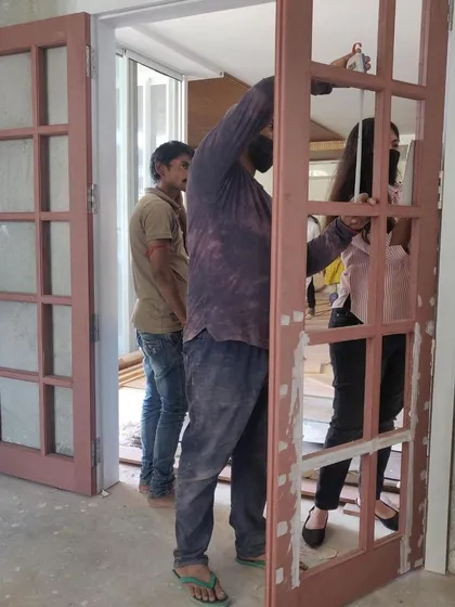 A behind-the-scenes shot of our team installing the custom-made double doors for the media room, a key part of the transformation process.