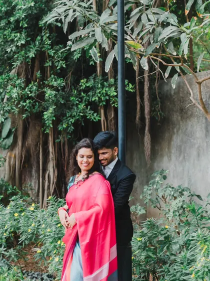 A sweet embrace from behind, captured in a verdant park. This pose is perfect for creating a sense of intimacy and protection.