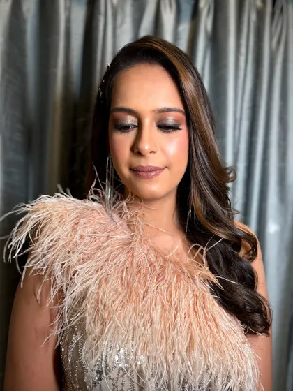 Eyes closed to showcase the blended, shimmery eyeshadow of this glamorous cocktail look.