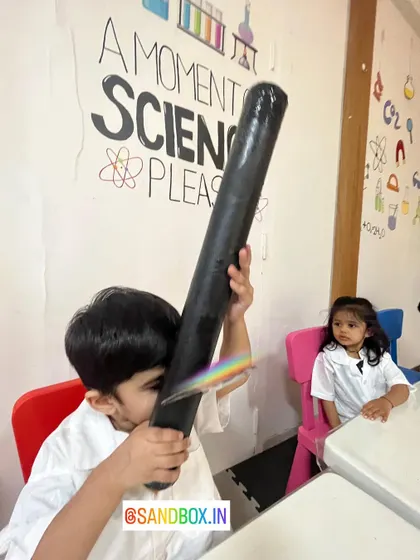 In our "A Moment of Science Please" corner, a student is busy exploring the colors of the light spectrum with his DIY spectroscope.