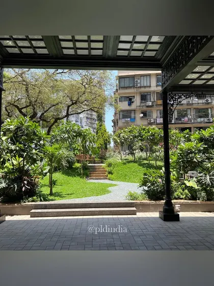 Looking out from an ornate, covered patio, the garden is framed as a living work of art. This perspective highlights how I design landscapes to be enjoyed from both within and outside the built structure, creating a seamless connection to nature.