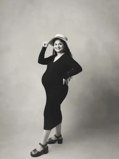 A playful and chic black and white portrait. The hat adds a touch of personality and style.