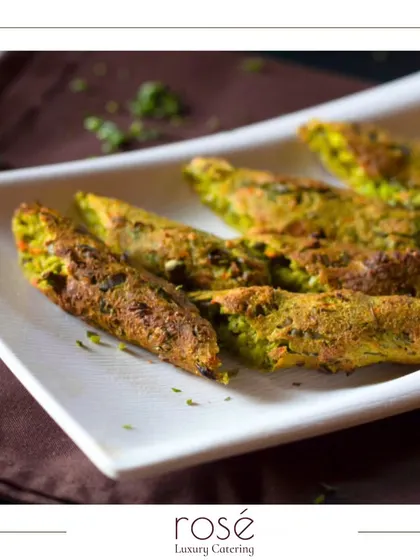 A plate of Hara Bhara Kebabs, a classic vegetarian appetizer made from spinach, peas, and potatoes. These are a healthy and delicious option for any event.
