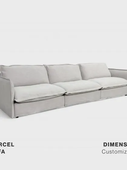 A studio shot of the customizable Marcel Sofa. Its simple, elegant form and generous cushions promise superior comfort, making it an ideal choice for those looking to create a relaxed yet sophisticated living room.