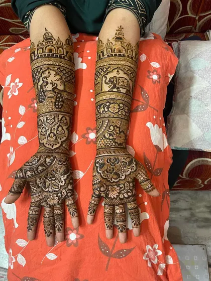 A classic full bridal mehndi with beautiful symmetry. The design includes peacocks at the top, elephants in the middle, and intricate floral and geometric patterns throughout.