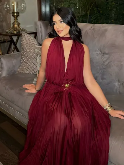 Serving looks from head to toe. Sana is the picture of modern glamour in this full-length shot, with her bronzed makeup perfectly complementing her elegant red dress.