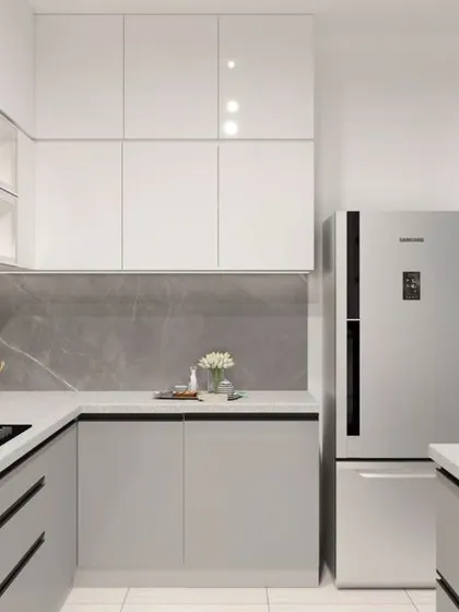 This parallel kitchen layout in white and grey offers extensive counter space and storage. The design includes a dedicated spot for the refrigerator, ensuring a clean, integrated look.