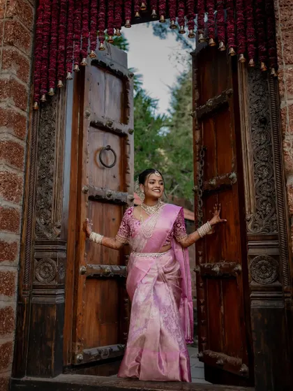 A beautiful bride framed by a traditional doorway. We use architectural elements and natural light to create artistic and striking portraits that highlight her grace.