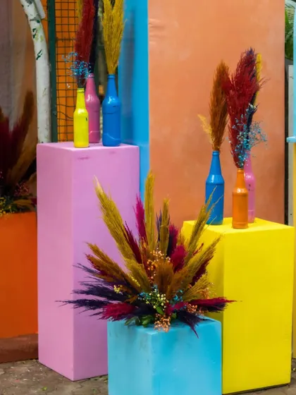 I used colorful blocks and painted bottles with pampas grass to create interesting decorative corners throughout the event space.
