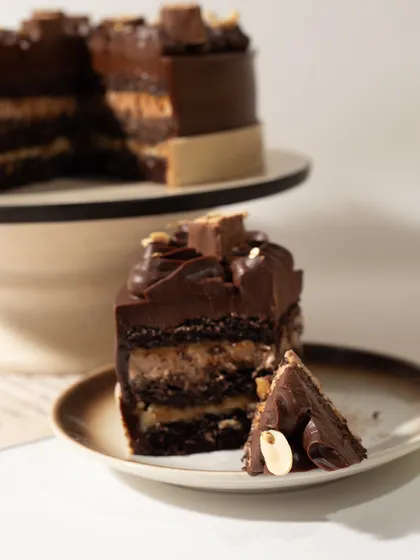 Another tempting shot of our Snickers Cake slice. We don't skimp on the good stuff, ensuring every bite is packed with flavor.