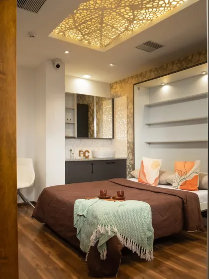 A luxurious bedroom setup from our Gurugram Experience Centre, featuring a Murphy bed and a vanity.