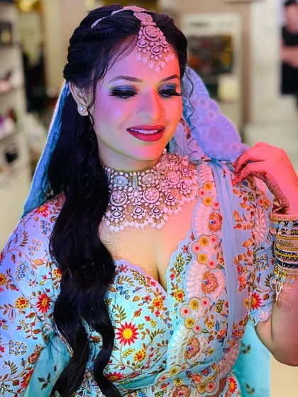 A lovely client in a floral light blue outfit. I created a fresh, dewy makeup look with a bold blue smoky eye to match her dress perfectly.