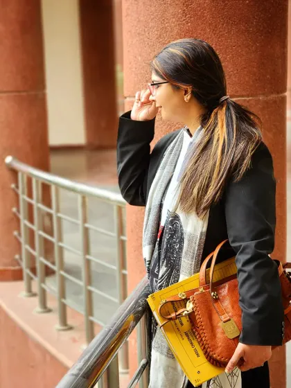 A lawyer's work often involves hours spent in court corridors, preparing for the next hearing. Here is my partner, Parul, between sessions, always focused on the case at hand.