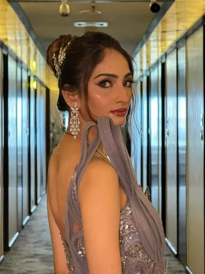 This bride looks absolutely radiant. The high bun hairstyle elongates the neck and highlights her stunning features and jewelry.