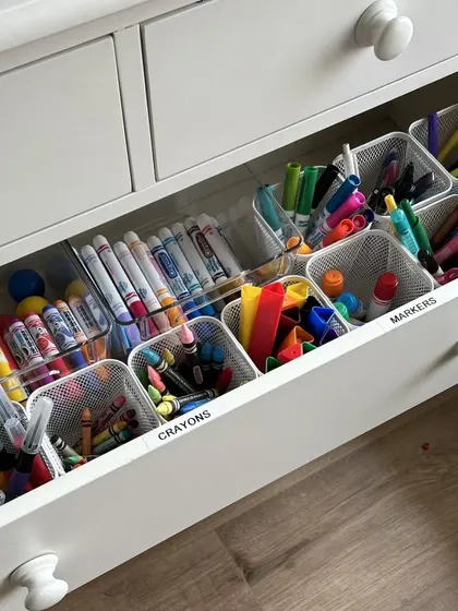 This art supply drawer is a child's dream. We used a combination of mesh and acrylic trays to organize crayons, markers, and pens, making creative time fun and cleanup simple.