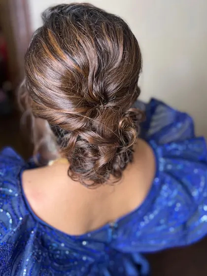 The only place we like it to be messy is in a beautiful hairstyle. This textured, low messy bun is a popular choice for receptions and cocktail parties.