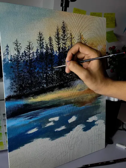 Another angle of the landscape painting in progress. This shot shows my hand adding fine details to the trees, demonstrating the careful brushwork required.