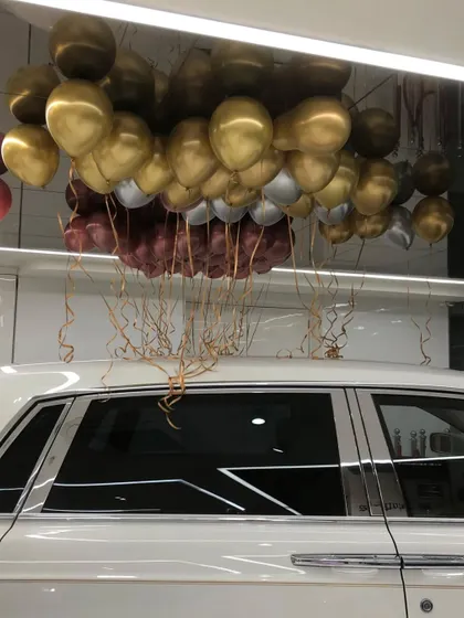 We even decorate cars. This surprise features a bunch of helium balloons ready to float out of a luxury car, perfect for a grand gesture or a special arrival.
