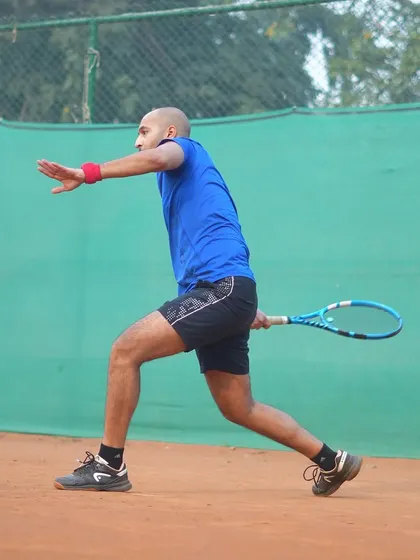 A player demonstrates perfect form during a forehand drill. Our coaching emphasizes progress over perfection, focusing on building solid technical fundamentals.