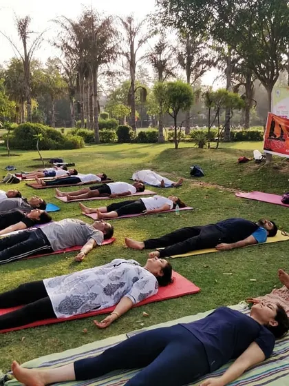 Ending our outdoor park session with Savasana (Corpse Pose). This final relaxation is essential for integrating the benefits of the practice, allowing the body and mind to rest completely.