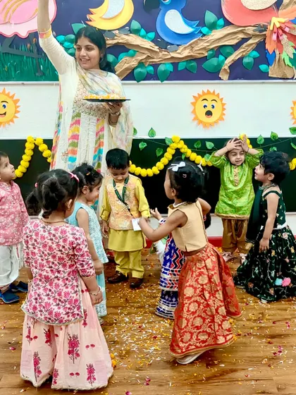 Showering flower petals during the Diwali celebration. This simple, joyful act filled the classroom with fragrance and festive cheer for our little stars.