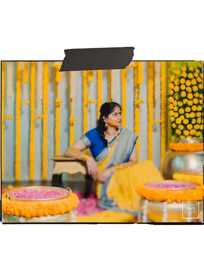 A beautifully composed portrait of the bride against a curtain of marigolds, capturing the vibrant yellow theme of the Haldi.