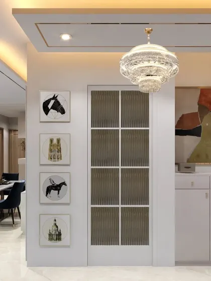 This gallery wall is integrated into the architecture of the home, with a fluted glass door and curated art pieces creating a sophisticated transition between spaces.