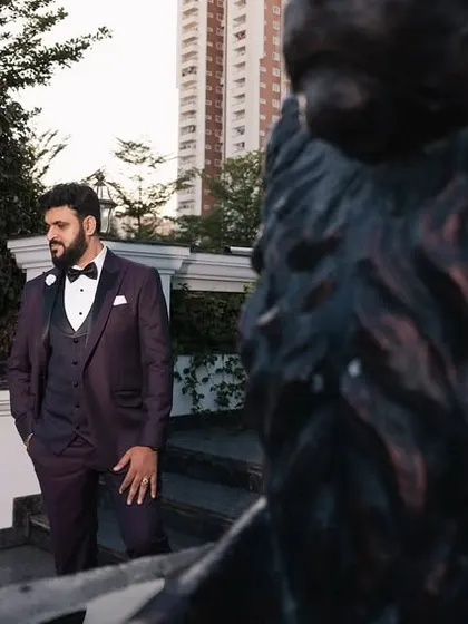 A groom looking sharp and ready for his reception. The framing with the lion statues adds a sense of grandeur and power to this stylish portrait.