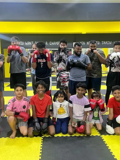 Our kids and teens geared up in boxing gloves, ready to train. We believe in starting the journey of discipline and strength from a young age.