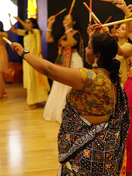 A group of women learning a sequence in a Garba line dance. We choreograph for all group sizes and skill levels.