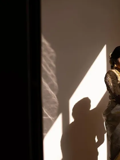 A quiet, artistic shot of the bride before her ceremony. The makeup is designed to look beautiful in all lighting conditions, from bright sunlight to soft indoor light.