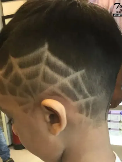 Another look at the intricate spiderweb hair design, showing the detail and precision of our stylists.
