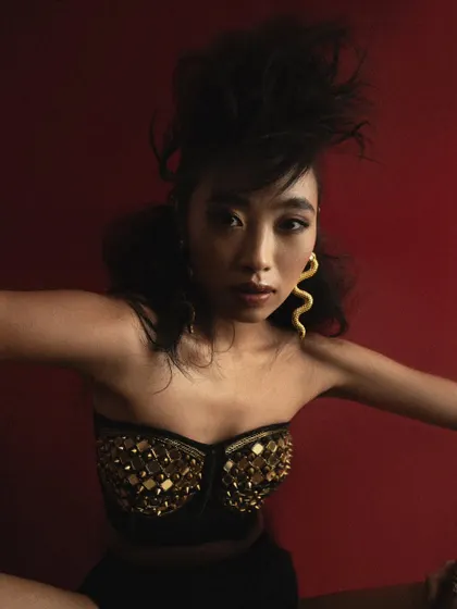 A wider shot from the "ETHEREAL" series, showing the interplay between the model's pose, the elaborate hair, and the studded bustier.