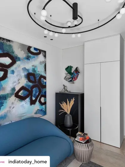 Another angle of the family room, showcasing how different art pieces and bold furniture can coexist. The space is designed to feel dynamic and inspiring, reflecting the homeowner's creative spirit.