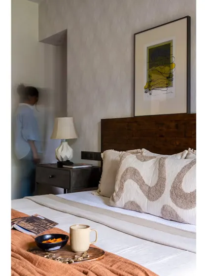 A press feature image of the rustic modern bedroom, highlighting the layered textures and cozy styling. The image captures the lived-in, comfortable charm that we strive to create in our personal spaces.