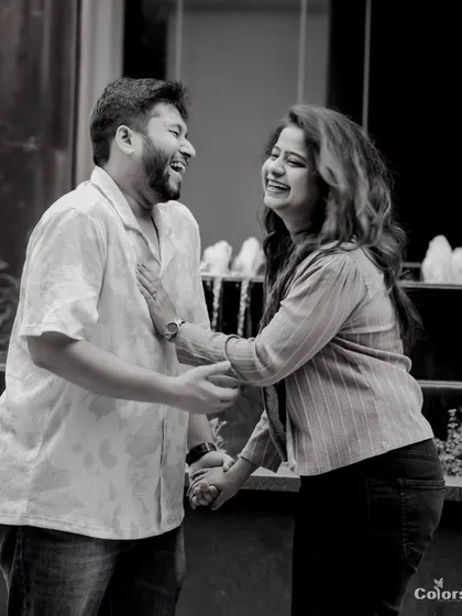 A black and white photo capturing a moment of shared laughter.
