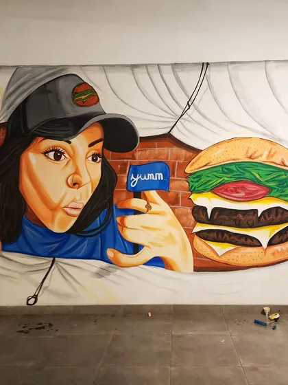 A wider view of the mural, showing how it creates a playful and surprising visual in the cafeteria.