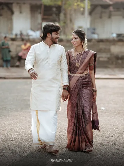 A sweet moment of a couple walking hand-in-hand after their wedding, sharing a happy glance.