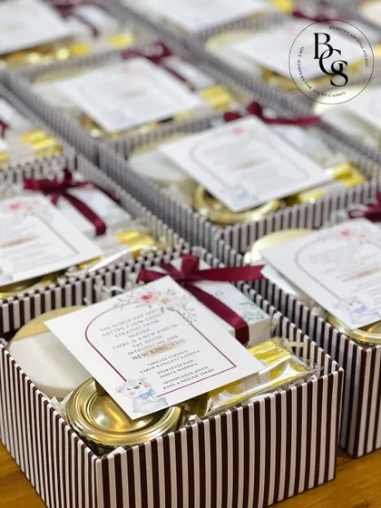 A collection of baby announcement gift boxes, featuring traditional Indian silver items and sweets. This is a wonderful way to blend modern gifting with cultural traditions when welcoming a new baby.