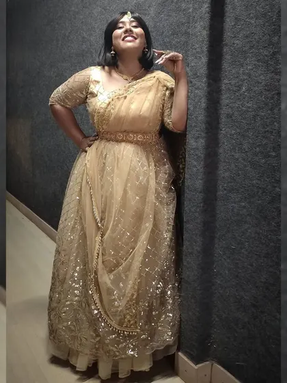 A joyful upward glance in the golden lehenga. This outfit was perfect for the festive atmosphere of the show.