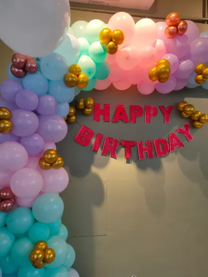 A basic pastel-colored balloon arch over a doorway, adding a touch of celebration to the home.