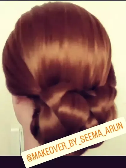 For a minimalist and elegant look, I offer simple styles like this sleek, low twisted bun. It's a timeless and sophisticated choice that keeps the focus on the client's face and outfit.