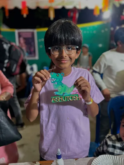 A young dinosaur fan with his awesome personalized T-Rex nameplate from our Sunday Soul Sante stall.