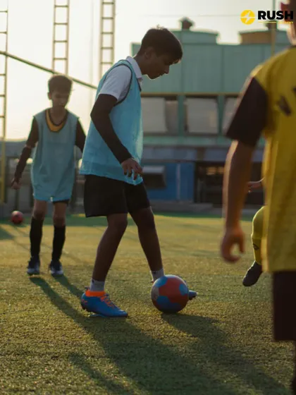 A player demonstrates focus and control while dribbling the ball during a drill.