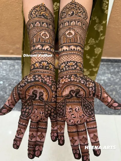 I love creating designs rich with symbolism. This bridal mehendi features twin peacocks on the palms, representing love and beauty, with rows of elephants for good luck.