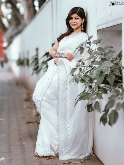 A duplicate of image 211, a full-length shot that captures the grace of the saree.