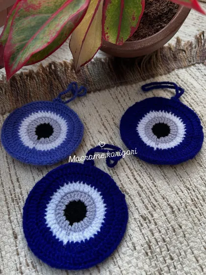 A set of evil eye charms, perfect for hanging in your car or home for protection. These are meticulously crocheted to capture the iconic design.